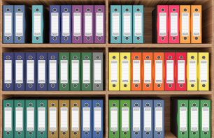 3D illustration. Series of folders of various colors wallets for document classification. Database. 
Library shelf database.