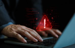 Cyber ​​attack alert on laptop. Cyber ​​attack on computer network. Virus, spyware, malware or malicious software. Businessman background.